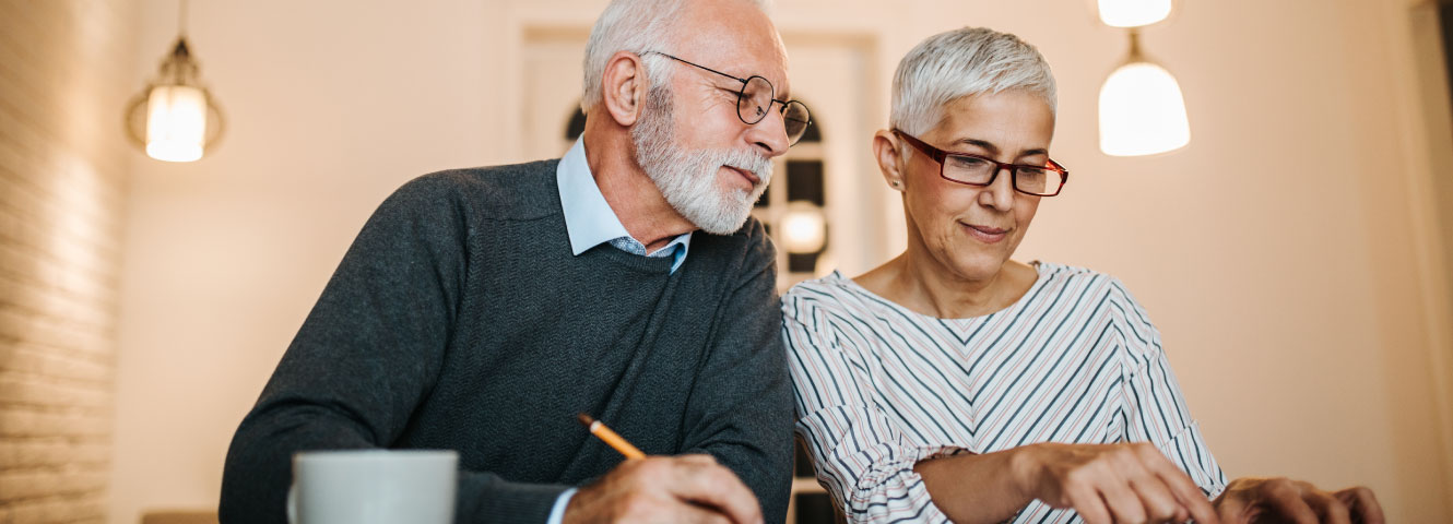 an older couple doing some paper work together