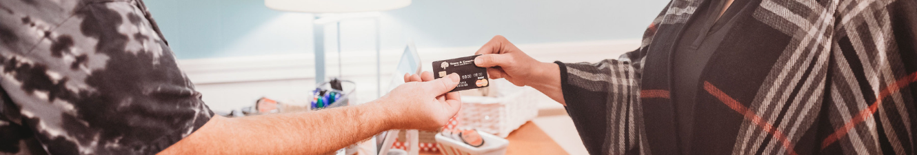 Customer handing over debit card to merchant