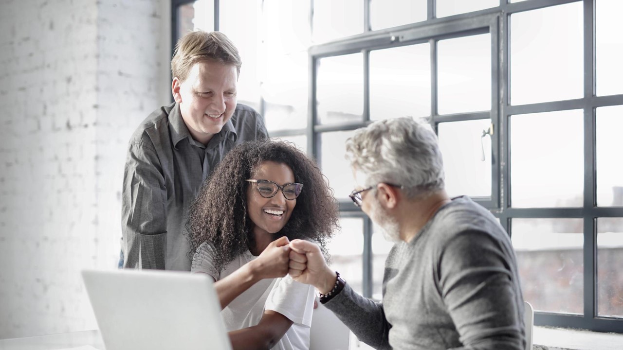 girl in glasses fist bumps man with gray hair